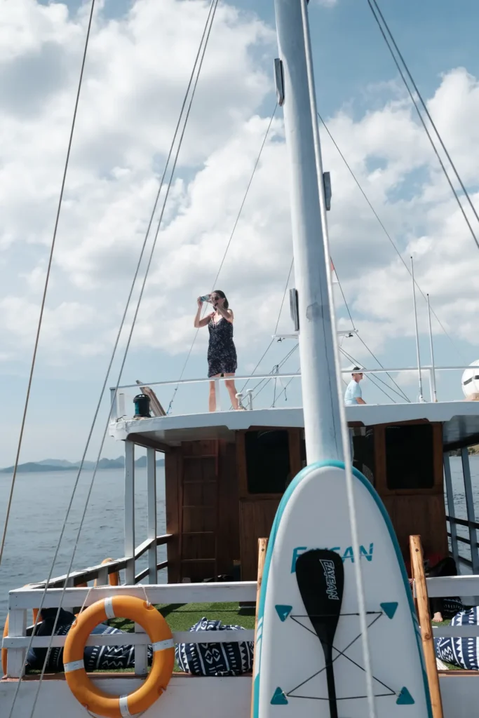 Paddleboards and canoe stored on the deck of Dinara