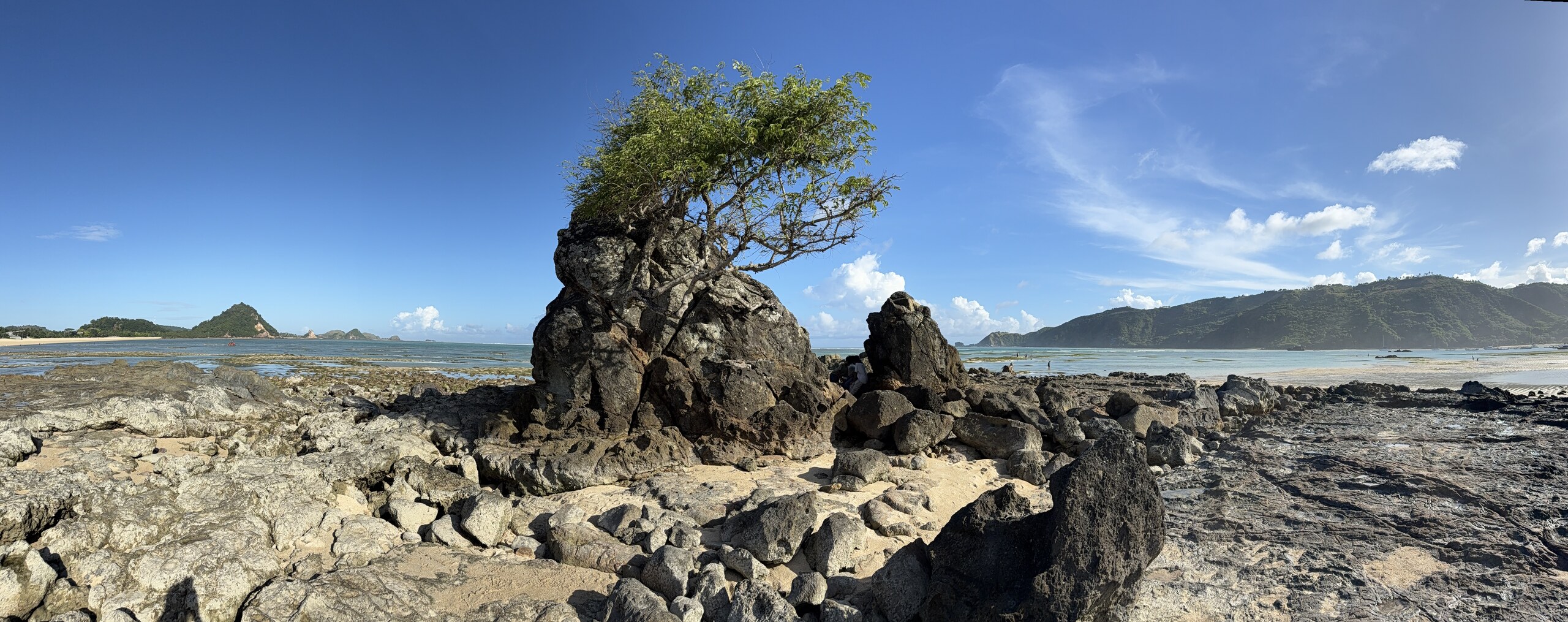 The rocky coastline of Belongas Bay in south Lombok under a wide sky