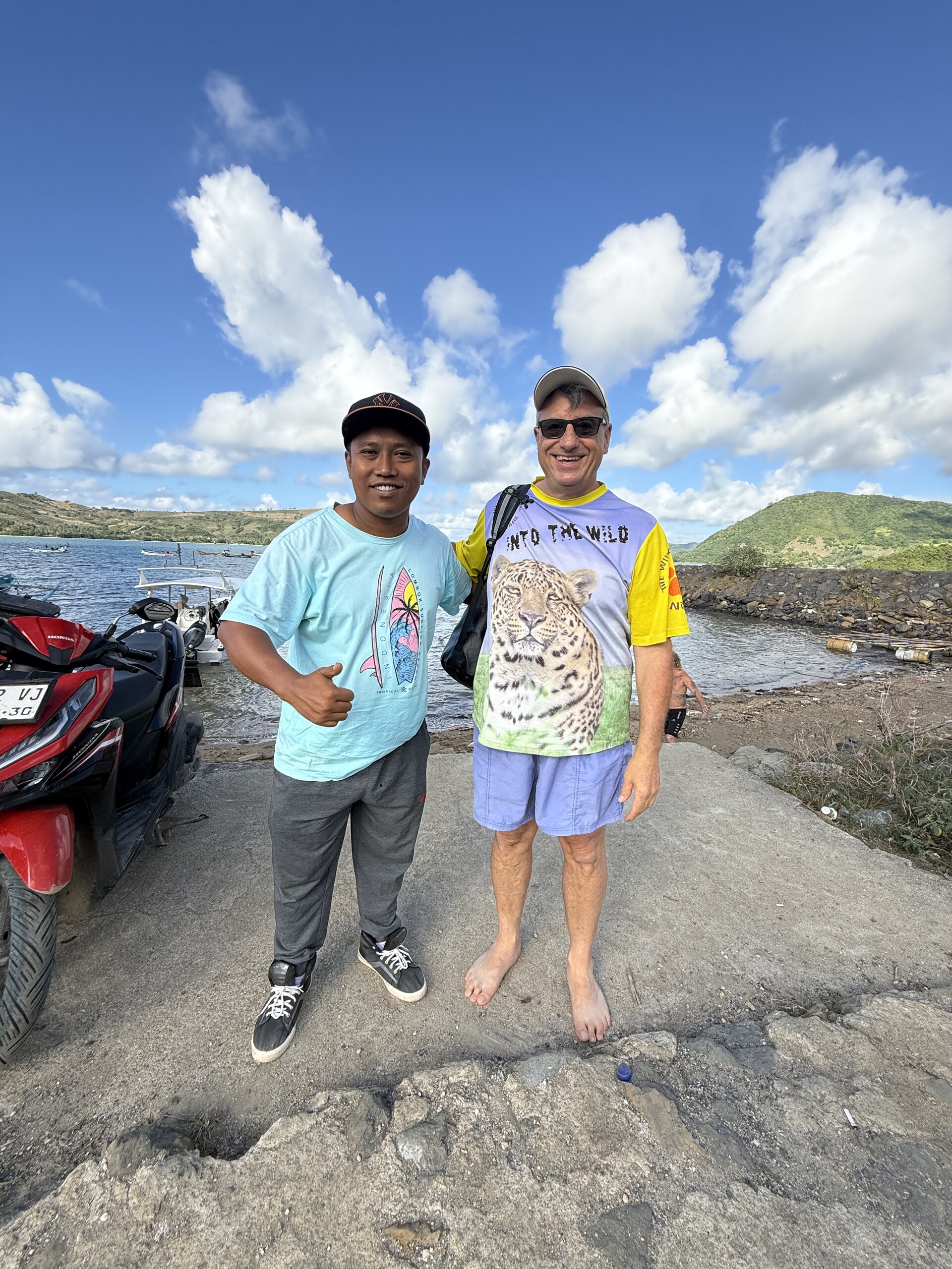 Divers at the water's edge on the rocky shore in south Lombok