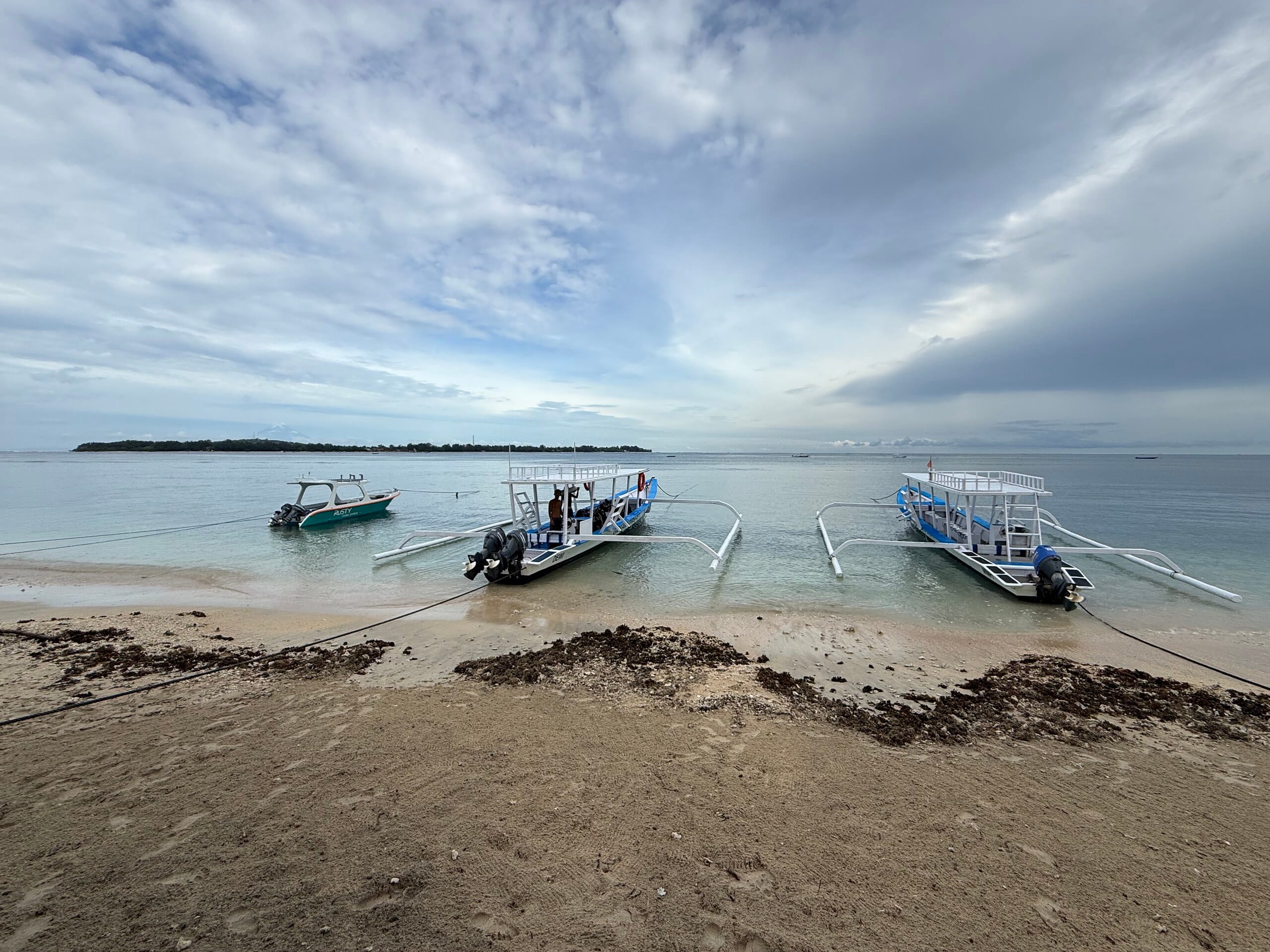 The shoreline of Gili Air with boats moored off the beach