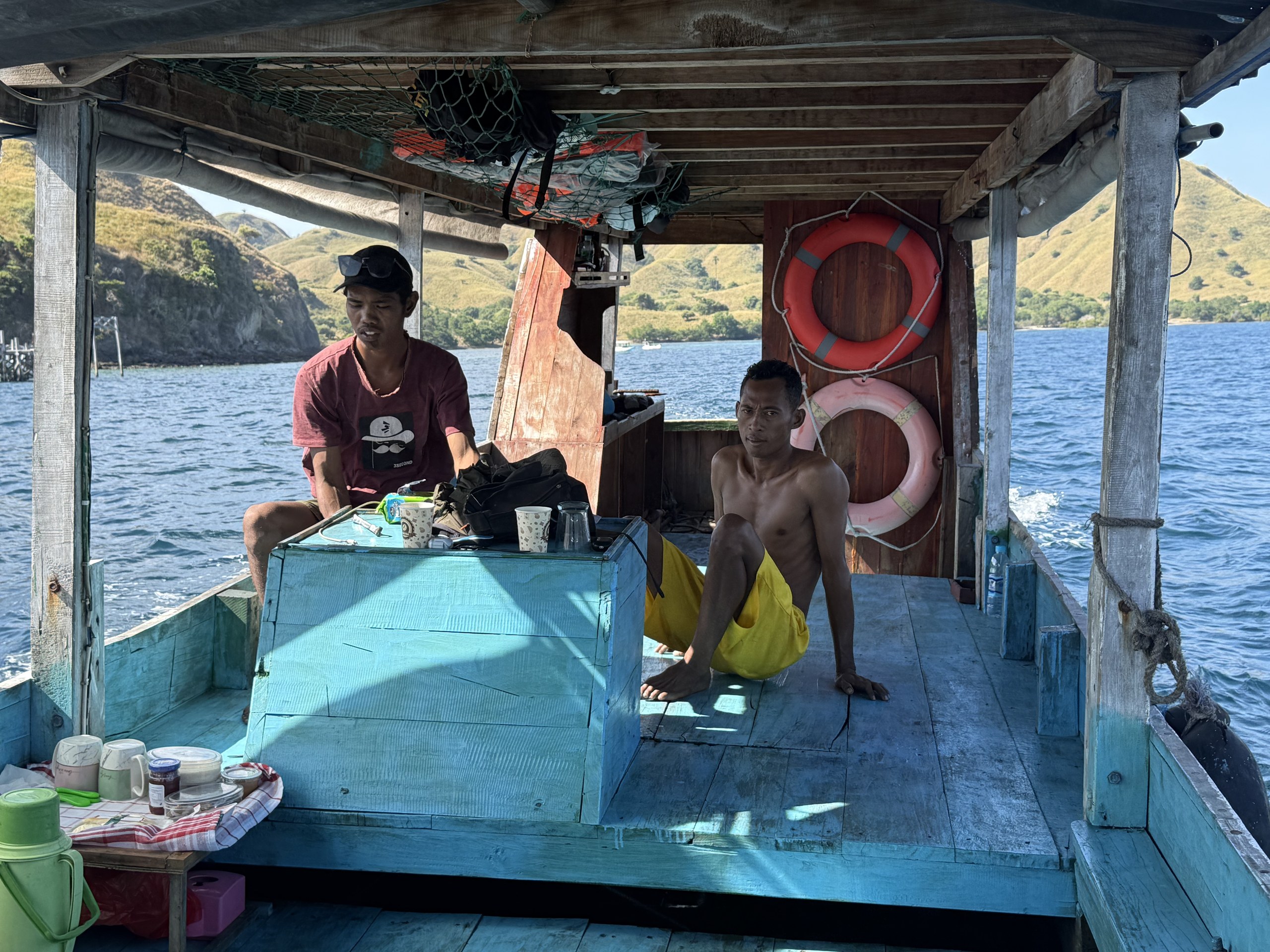 The crew of a small wooden boat in the Komodo archipelago