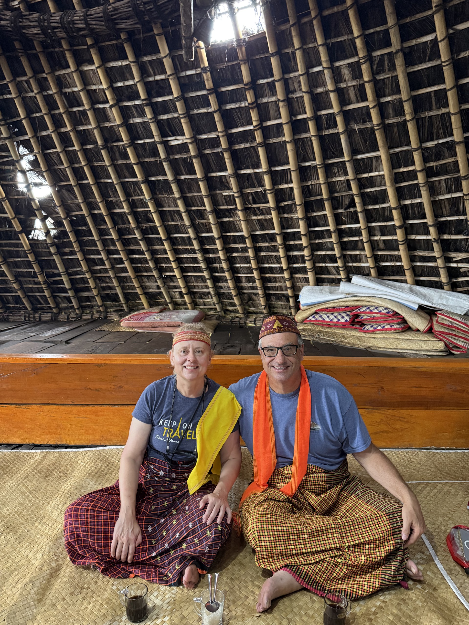 Passengers sitting on the bow of a wooden boat crossing to Komodo