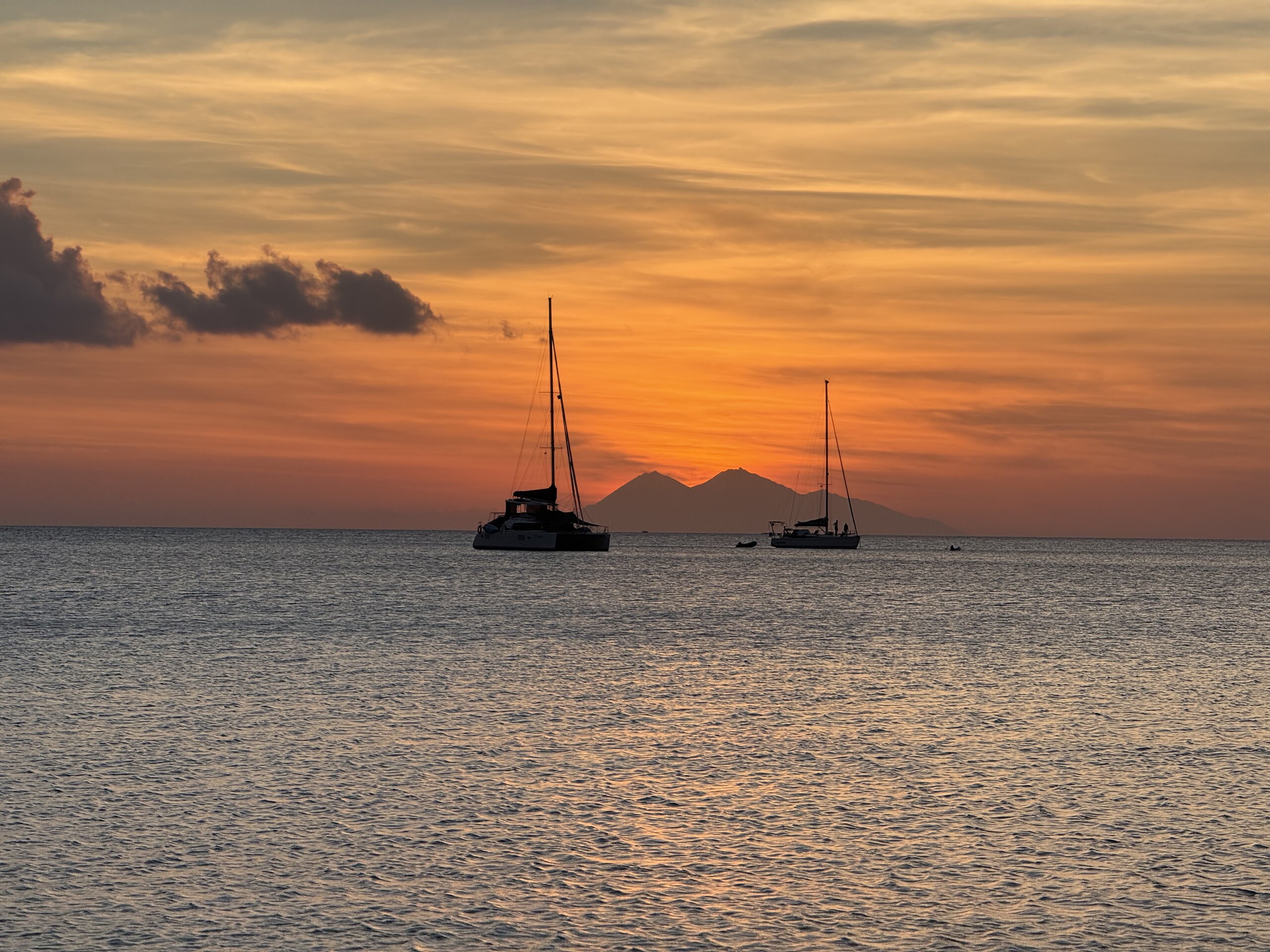 Sailing boats silhouetted against the sunset off Labuan Bajo