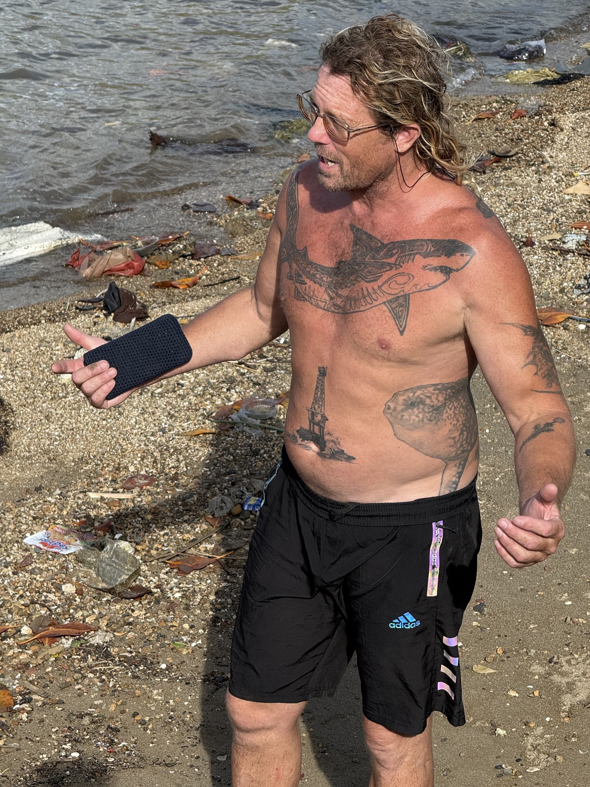 Jay, founder of Wild Scuba Indonesia on the rocky shore at Belongas Bay
