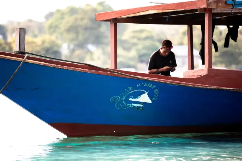The wooden dive speedboat of La P'tite Kepa moored off Kepa island
