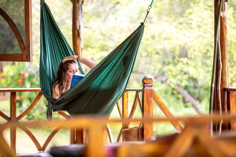 A guest reading in a hammock on the terrace of an Exclusive Deluxe bungalow