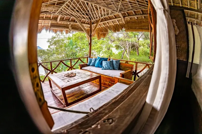 Inside an Exclusive Deluxe bungalow looking out to the terrace and the sea