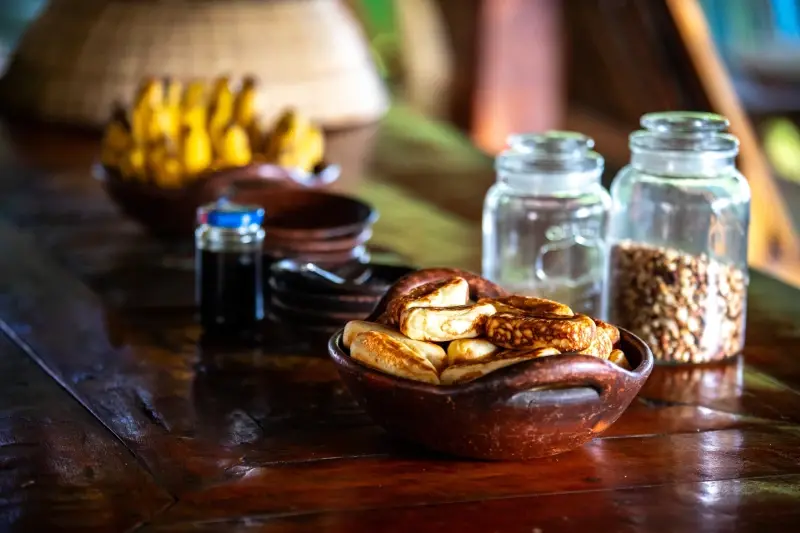 Breakfast on the table at La P'tite Kepa, bananas, fresh cakes and coffee