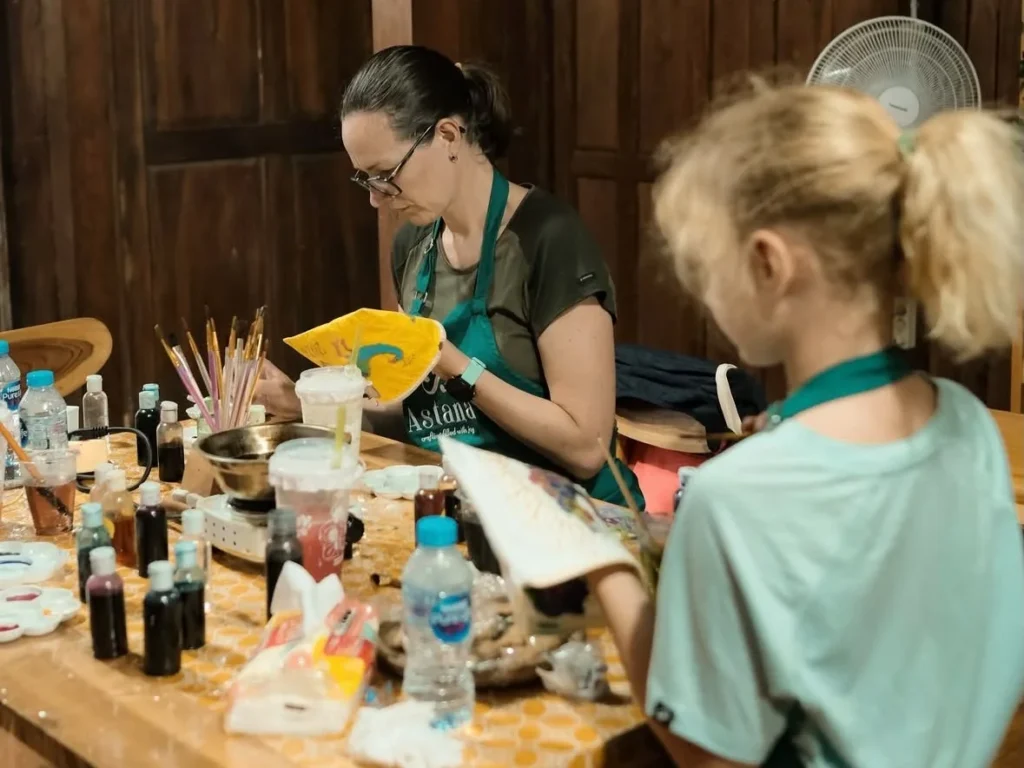 Family working on batik cloth at Astana Workshop Batik