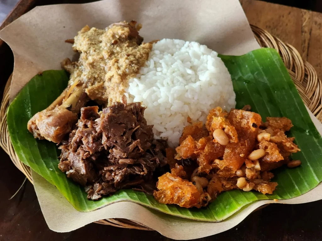 Plate of gudeg with rice, egg and krecek on a banana leaf on Jalan Wijilan