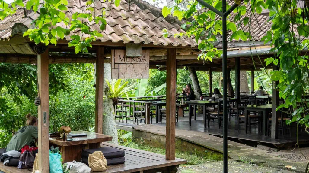 Open wooden dining pavilions in the garden at Moksa