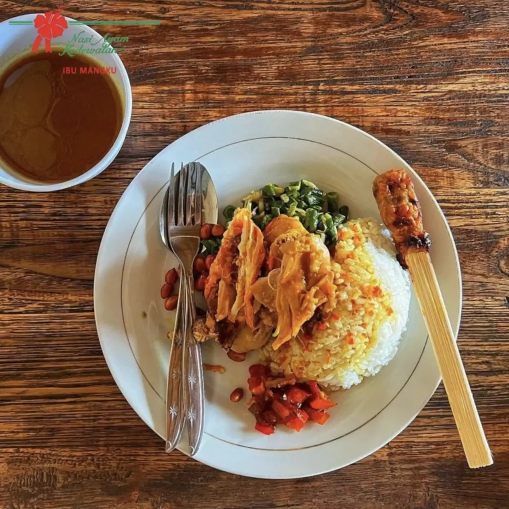 Plate of nasi ayam with shredded chicken, sate lilit and sambal at Ibu Mangku