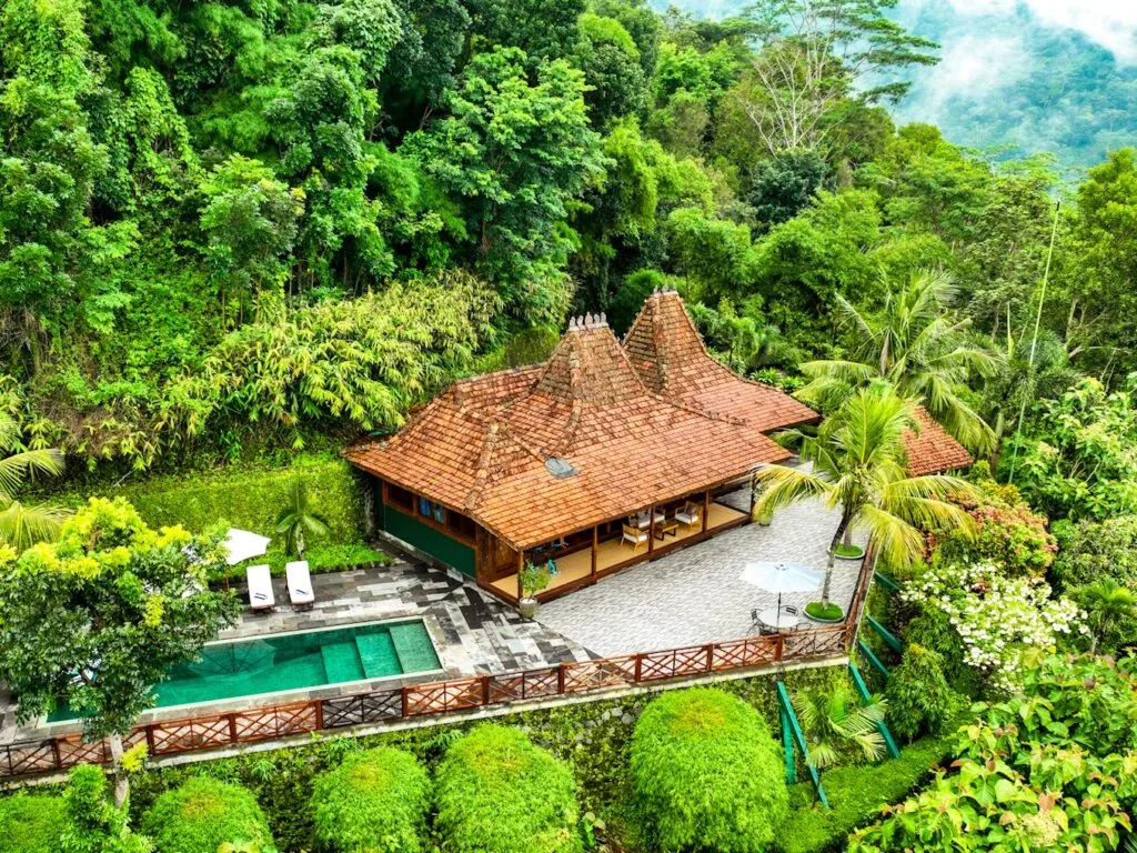 Aerial view of a joglo villa with a private pool at Villa Borobudur Resort in the Menoreh hills
