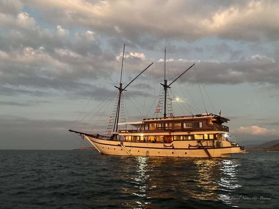 Al Fatran 3, a wooden phinisi, at anchor at sunset