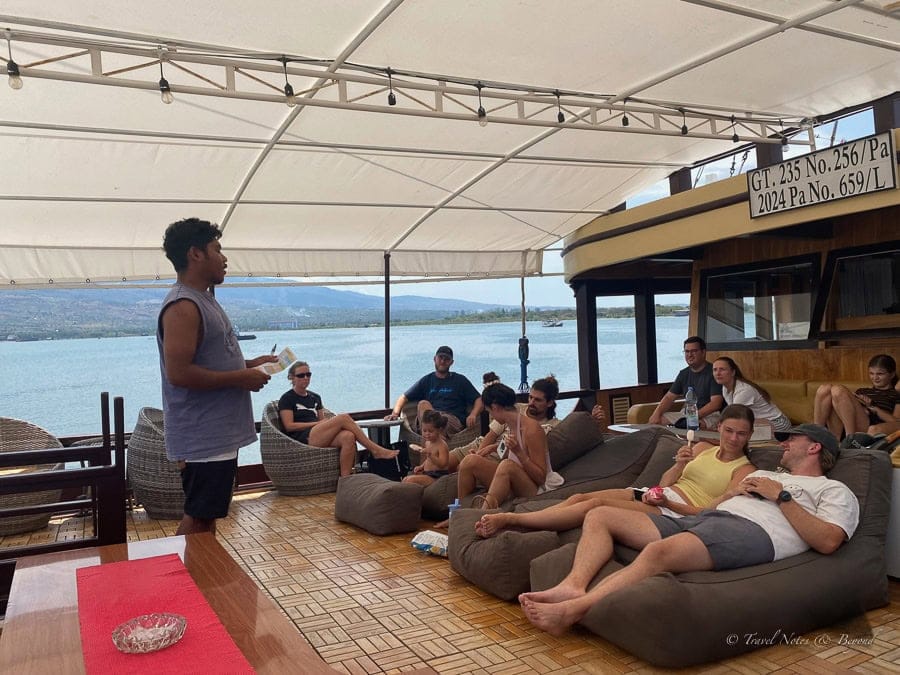 A crew member briefing guests on the main deck on the first afternoon