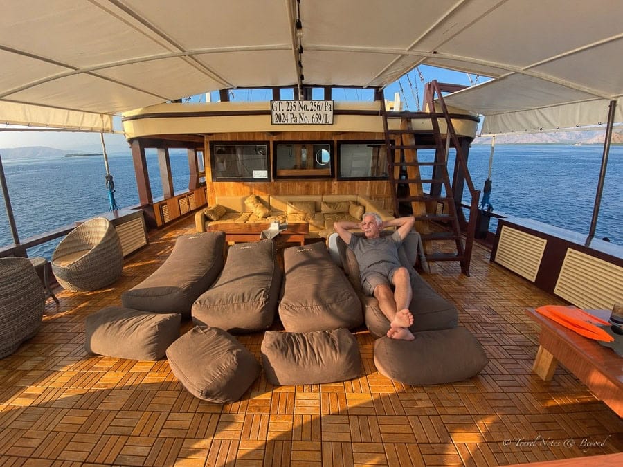 Bean bags and a cream sofa under the canopy on the main deck of Al Fatran 3