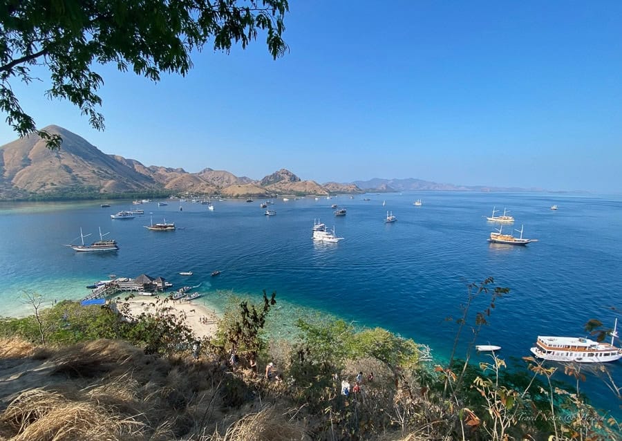 Boats anchored in the turquoise bay below the Kelor Island viewpoint