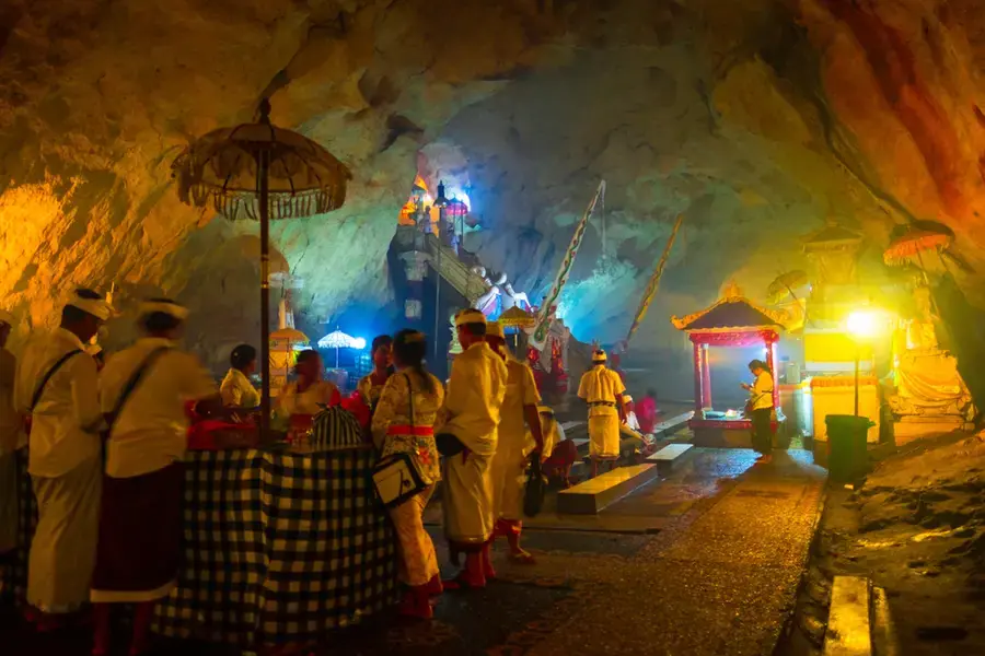 Balinese pilgrims in white at a shrine inside Goa Giri Putri cave on Nusa Penida