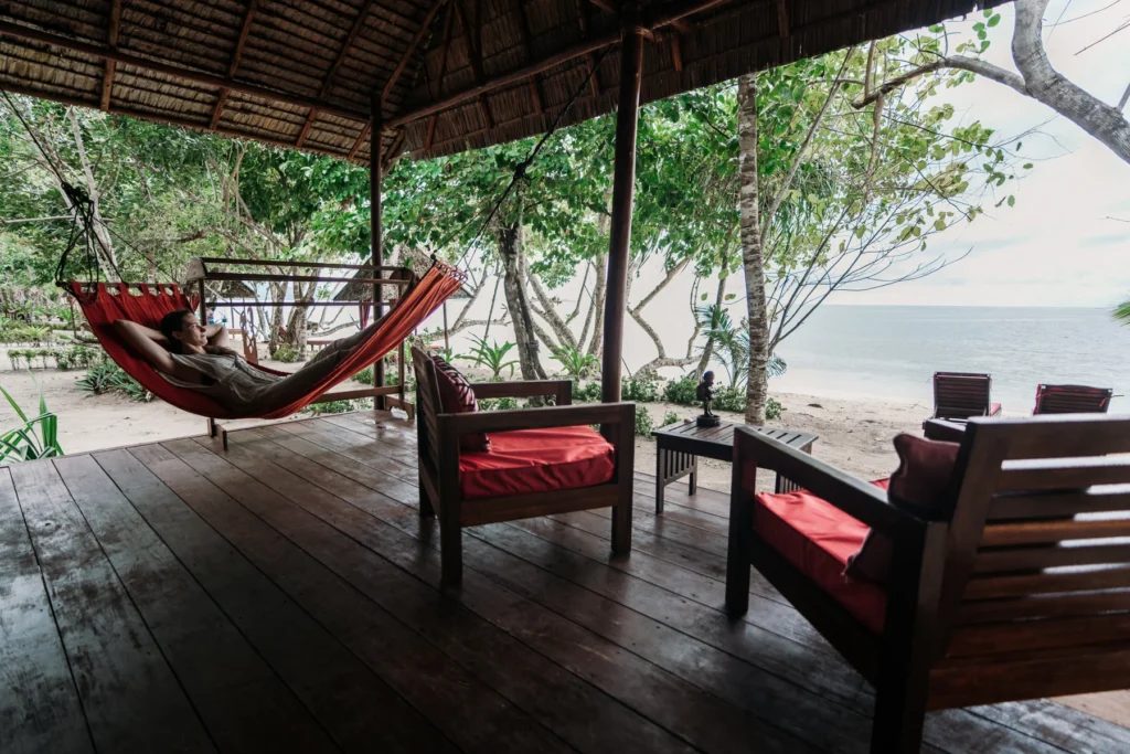 Deluxe Cottage terrace with a hammock and chairs looking out to the sea