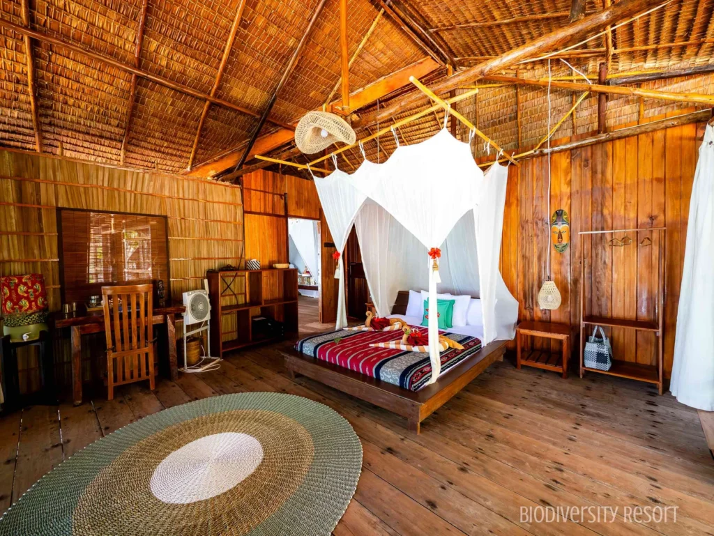 Deluxe Cottage Suite main bedroom with a queen-size bed under a mosquito net